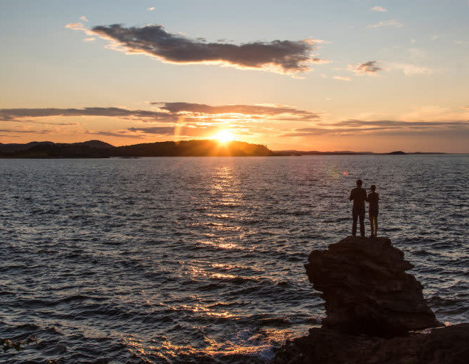 Presque Isle Park - couple standing on a rock over looking the lake