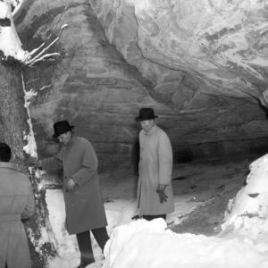 investigators walking the cave crime scene